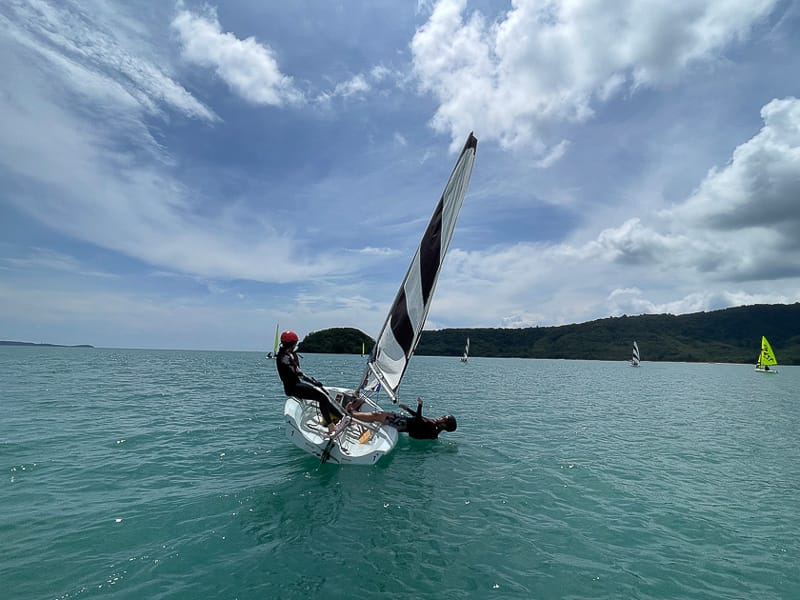 Hartley 12s dinghy sailing on tropical blue water during a practical Java Yachting sailing course in Thailand.