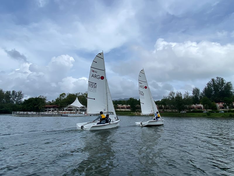 Two Topper Argo sailing dinghies underway during practical sailing instruction with Java Yachting in Thailand.
