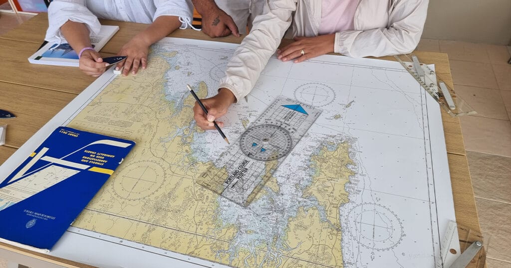 International Crew students learning marine navigation and chartwork with Java Yachting in Thailand