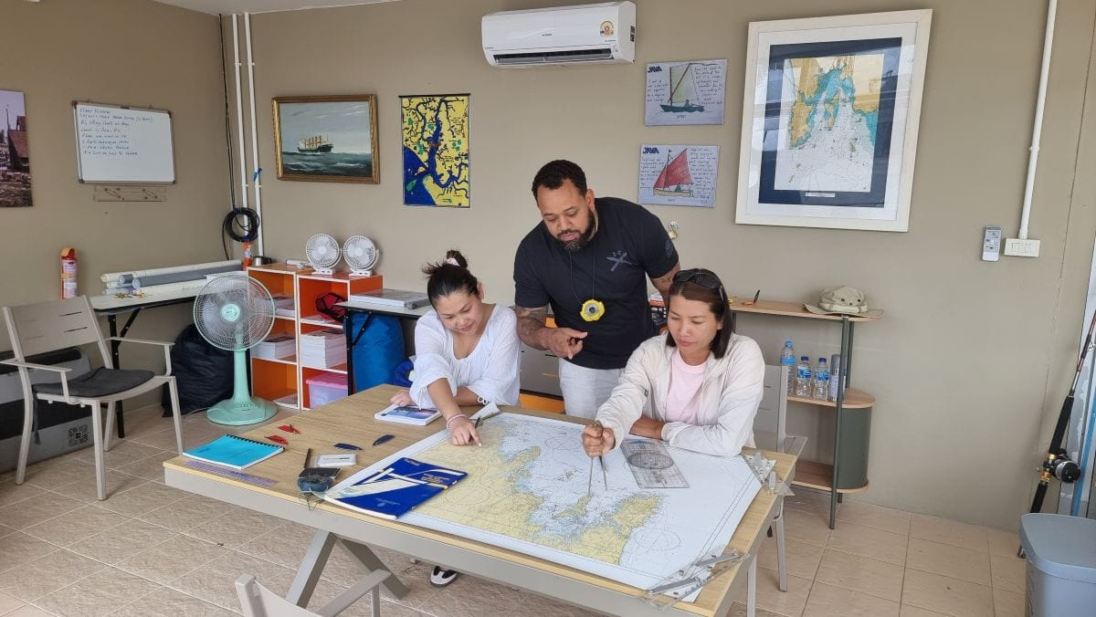 Java Yachting instructor teaching marine navigation and chartwork to students in the Krabi training classroom
