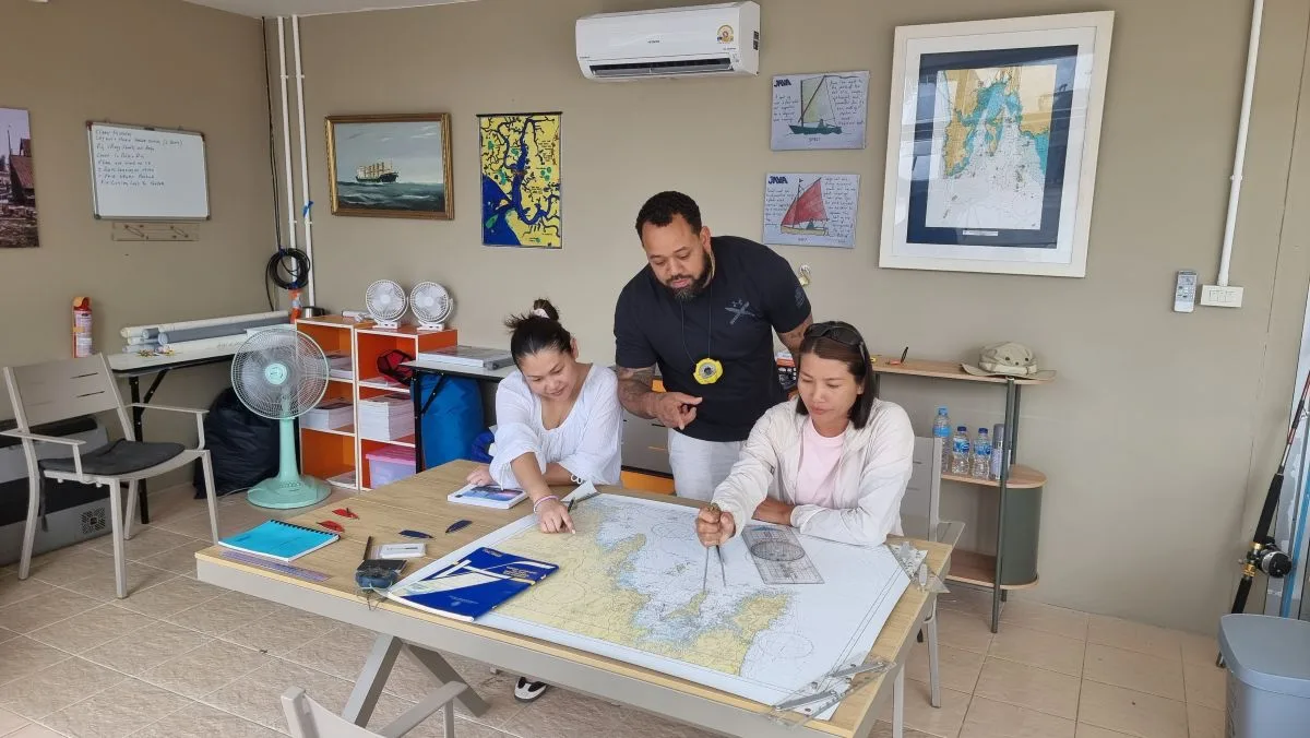 Java Yachting instructor teaching marine navigation and chartwork to students in the Krabi training classroom