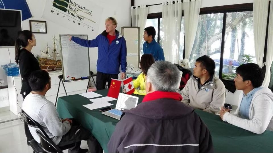 Instructor teaching students during an International Yacht Training classroom course at Java Yachting