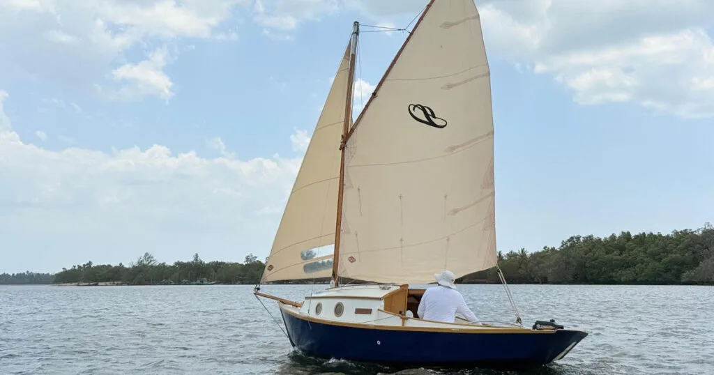 Stornaway 18 traditional sailing boat underway among mangroves in Krabi, Thailand