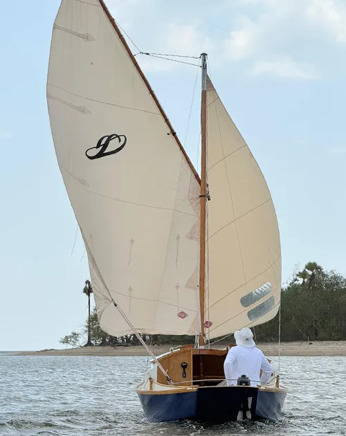 Stern view of Stornaway 18 sailing with cream sails in Krabi, Thailand