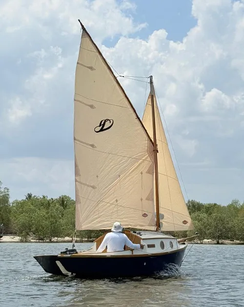 Stornaway 18 traditional sailing boat underway among mangroves in Krabi, Thailand