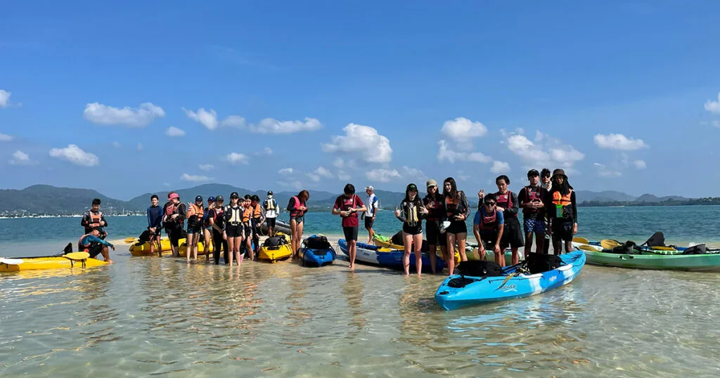 Students completing a kayaking team-building activity with Java Yachting in Thailand