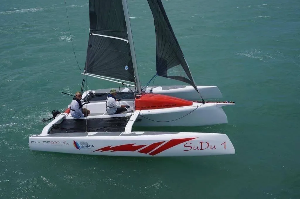 Pulse 600 performance sailing catamaran underway with two sailors aboard
