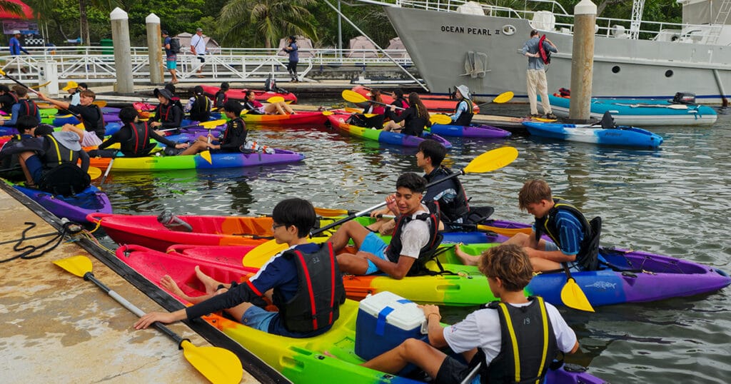 Students preparing for a team-building kayaking activity at Krabi Boat Lagoon, Thailand