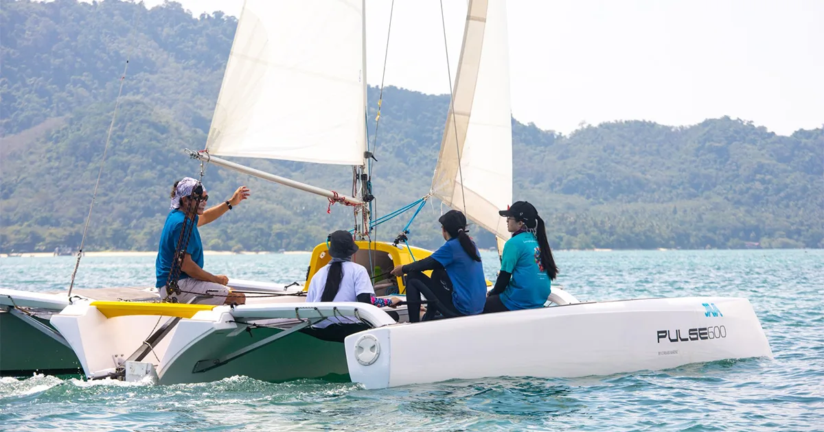 Java Yachting instructor teaching students practical sailing aboard a Pulse 600 trimaran in Thailand